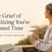Cozy sage-green workspace with a journal and coffee mug beside the title "The Grief of Realizing You've Wasted Time (And Why It's Not Too Late)," symbolizing a fresh start and midlife renewal.